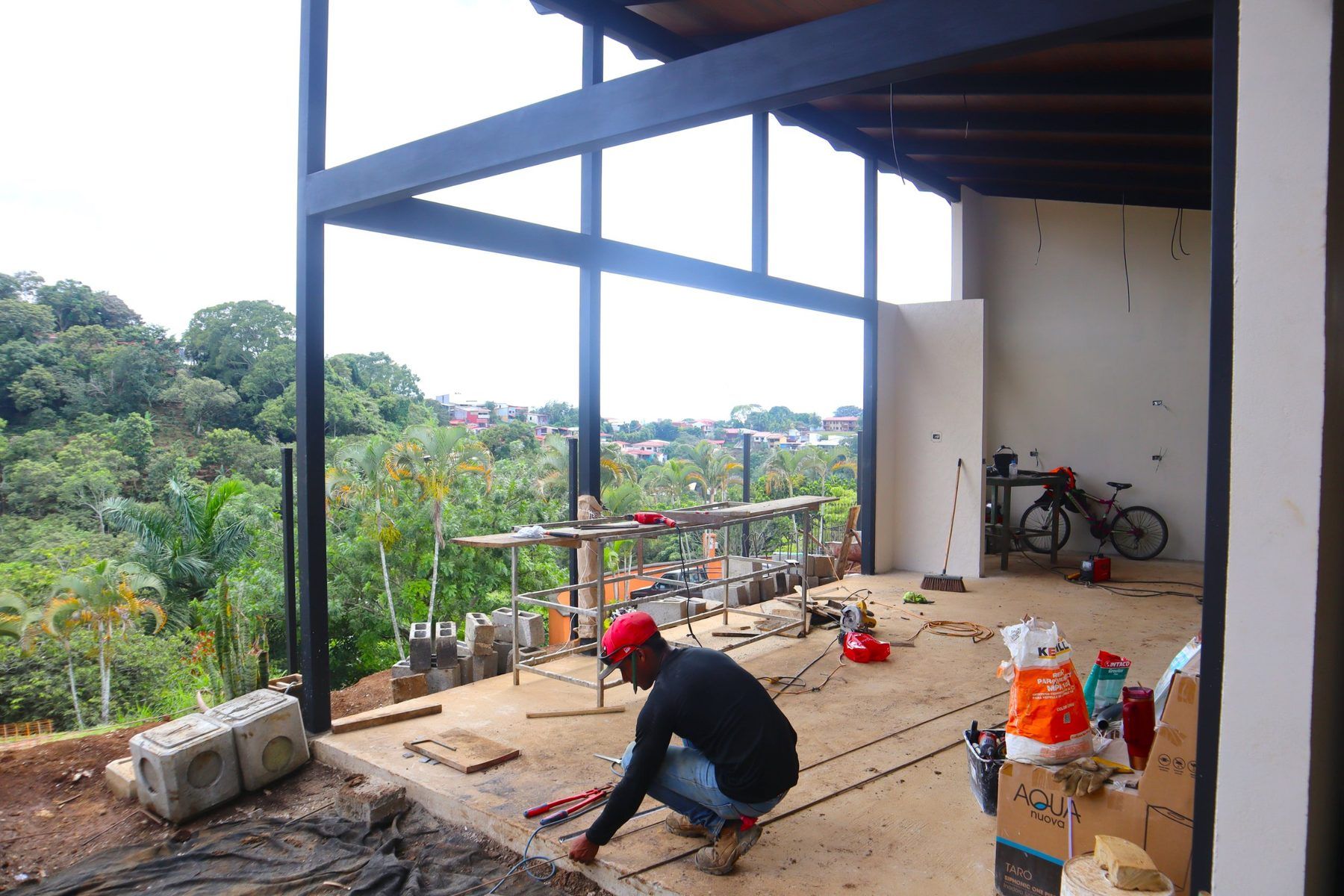 Ventanal de doble altura del área social con vista al valle, en construcción